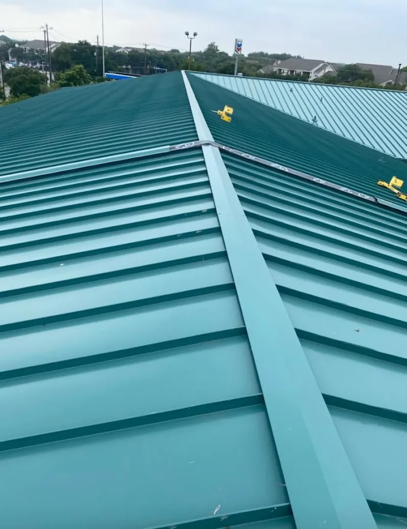 Green commercial metal roof ridge and valley for Metal Roof Repair in Potsdam