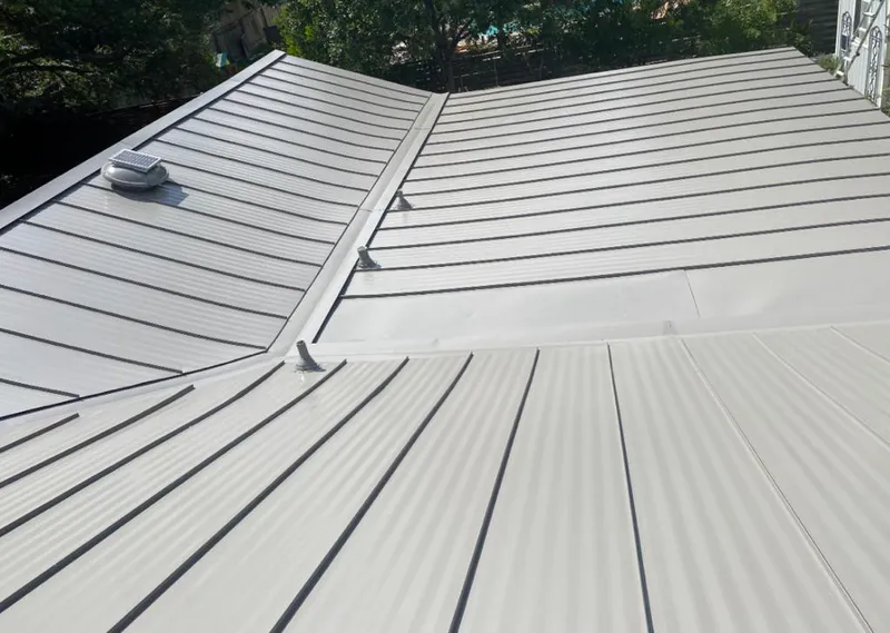 Solar attic fan installed on a metal roof for Roof Ventilation in Potsdam